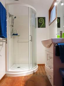 In the bathroom there's a shower, a heated towel rail, well-lit handbasin/mirror, and a toilet.