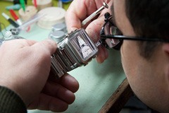 Tim closely inspects a Seiko watch for repair.